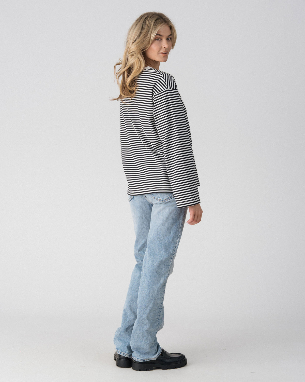 Lenelly Lena oversized striped nursing tee in black and white, side view showing the drop shoulder and relaxed fit