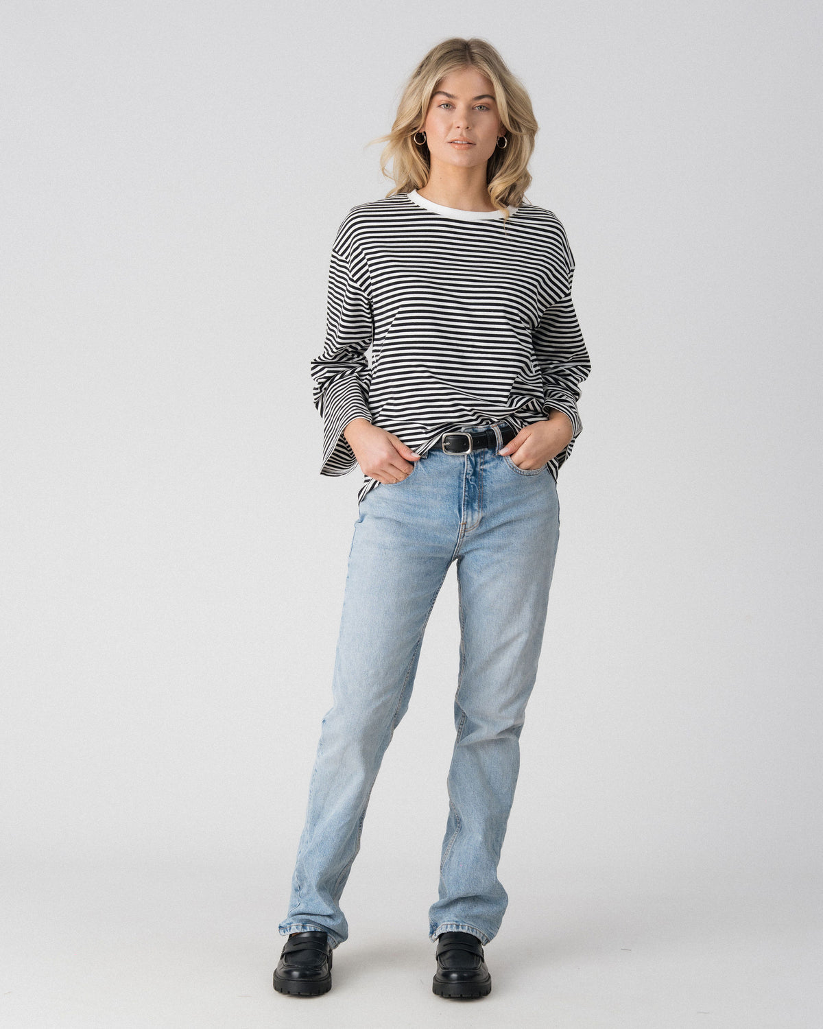 Lenelly Lena long sleeve striped tee in black and white worn tucked with a belt, front view