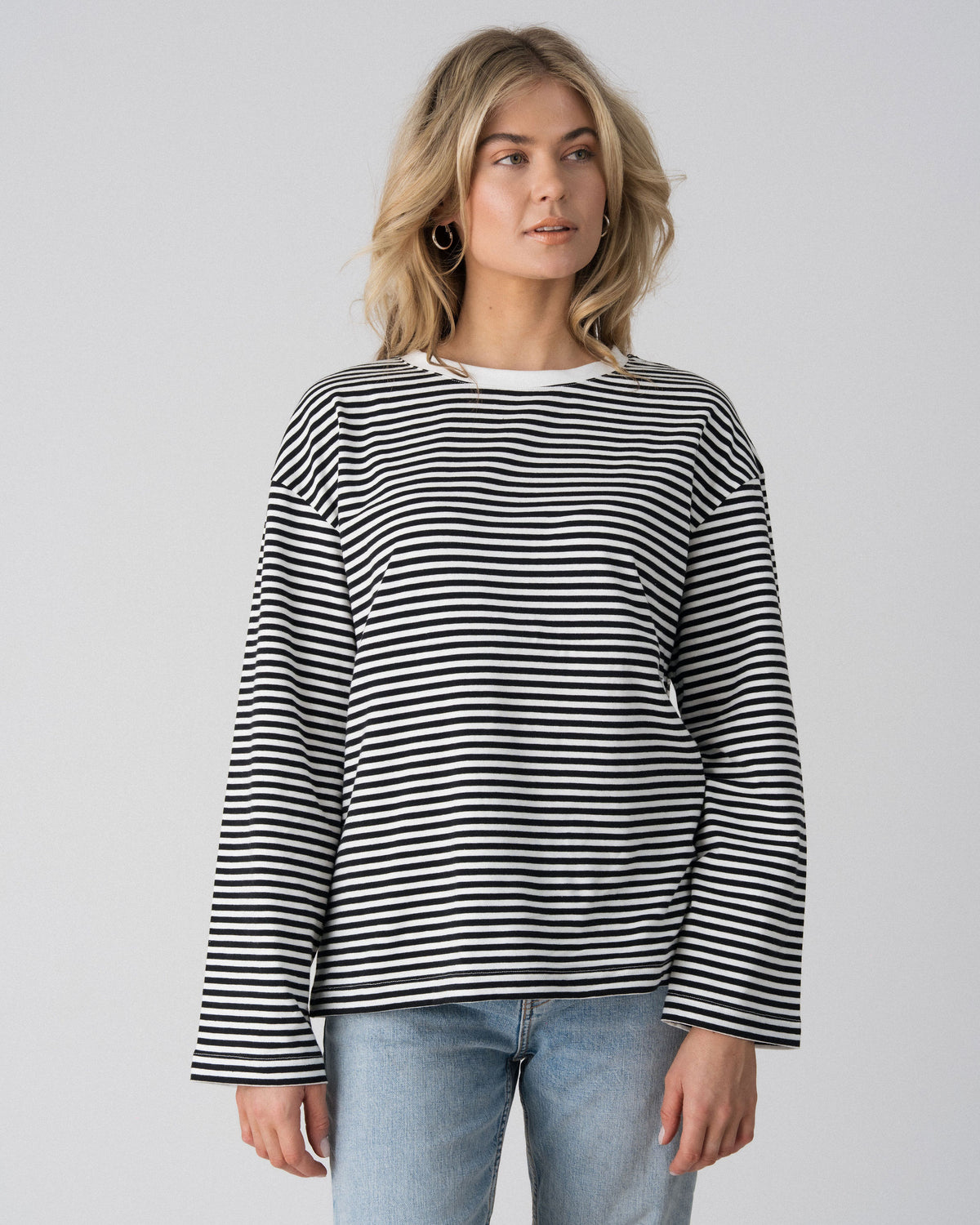 Close-up of the Lenelly Lena oversized nursing tee in black and white stripe, showing the wide sleeve and crew neckline