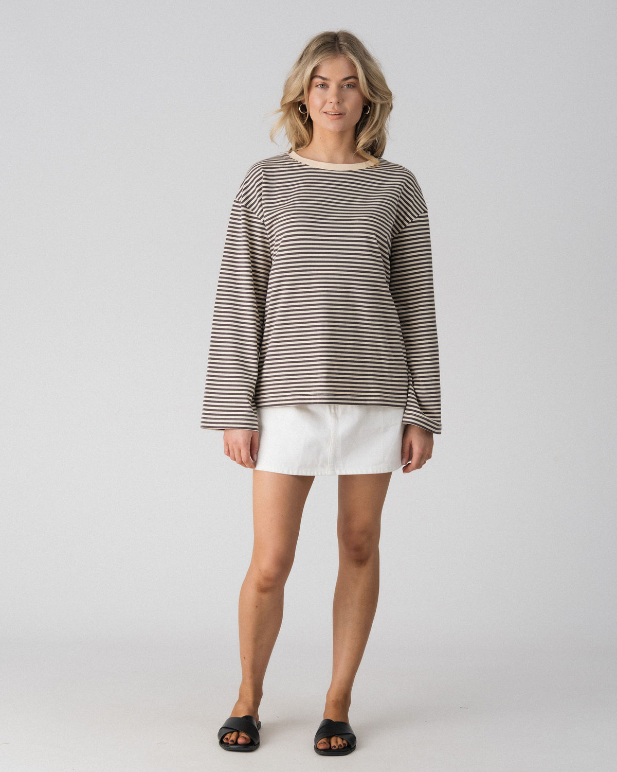 Lenelly Lena oversized long sleeve nursing tee in grey and off-white stripe, a breastfeeding-friendly top styled with a white denim skirt, front view