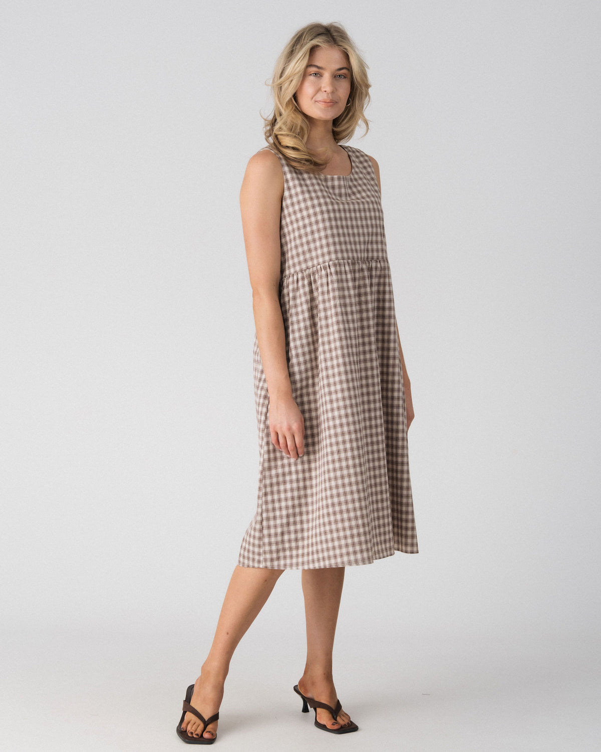 Lenelly Nila plaid midi dress in beige and brown check, angled view showing the relaxed babydoll silhouette
