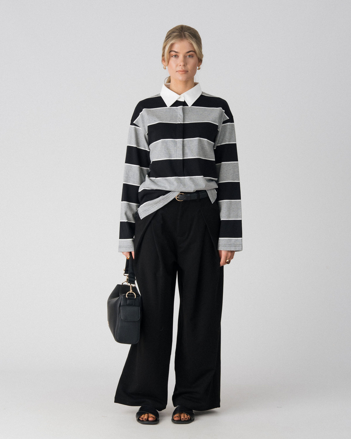 Lenelly Erika rugby polo in black and grey stripe worn with the Lenelly Hera pram caddy bag in black