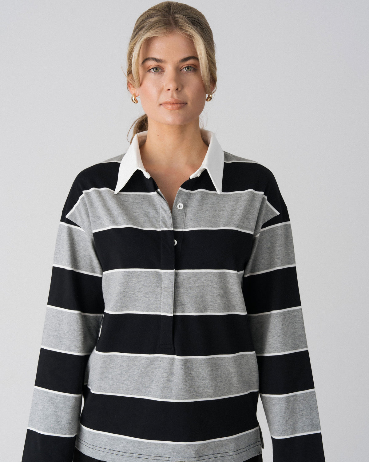 Close-up of the white collar and concealed button placket on the Lenelly Erika rugby nursing polo