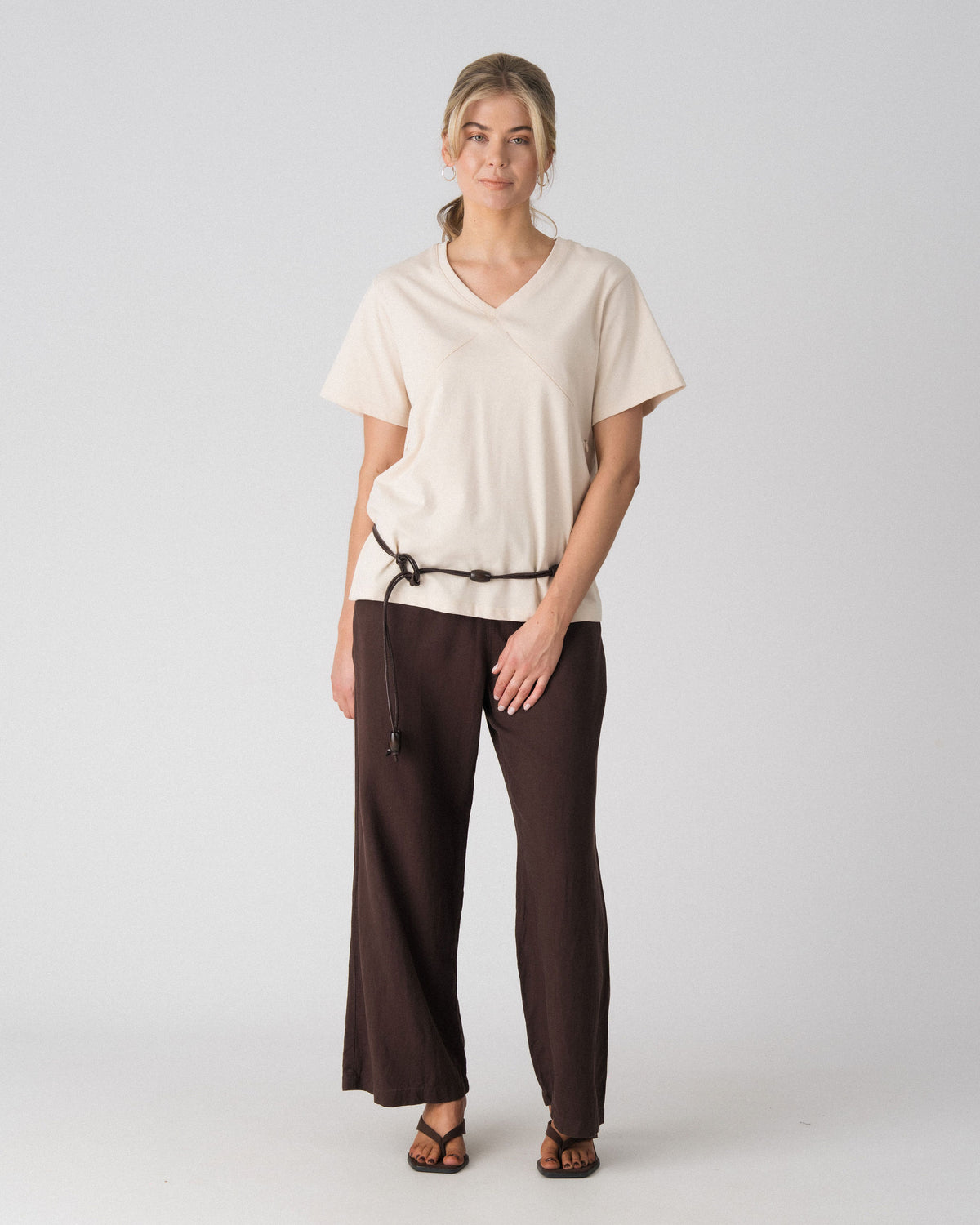 Lenelly Avery V-neck nursing tee in sand, an oversized breastfeeding-friendly tee styled with a cord belt and wide leg trousers, front view