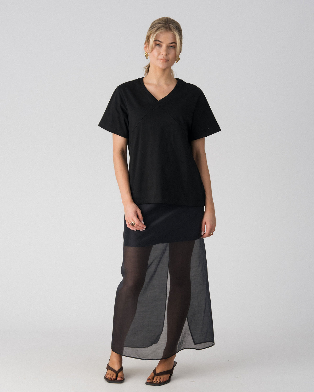 Lenelly Avery V-neck nursing tee in black, an oversized breastfeeding-friendly tee styled with a sheer maxi skirt, front view