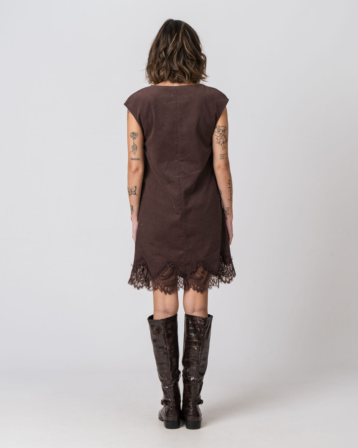 Back view of the Lenelly Audrey corduroy dress in chocolate brown with delicate lace trim hem
