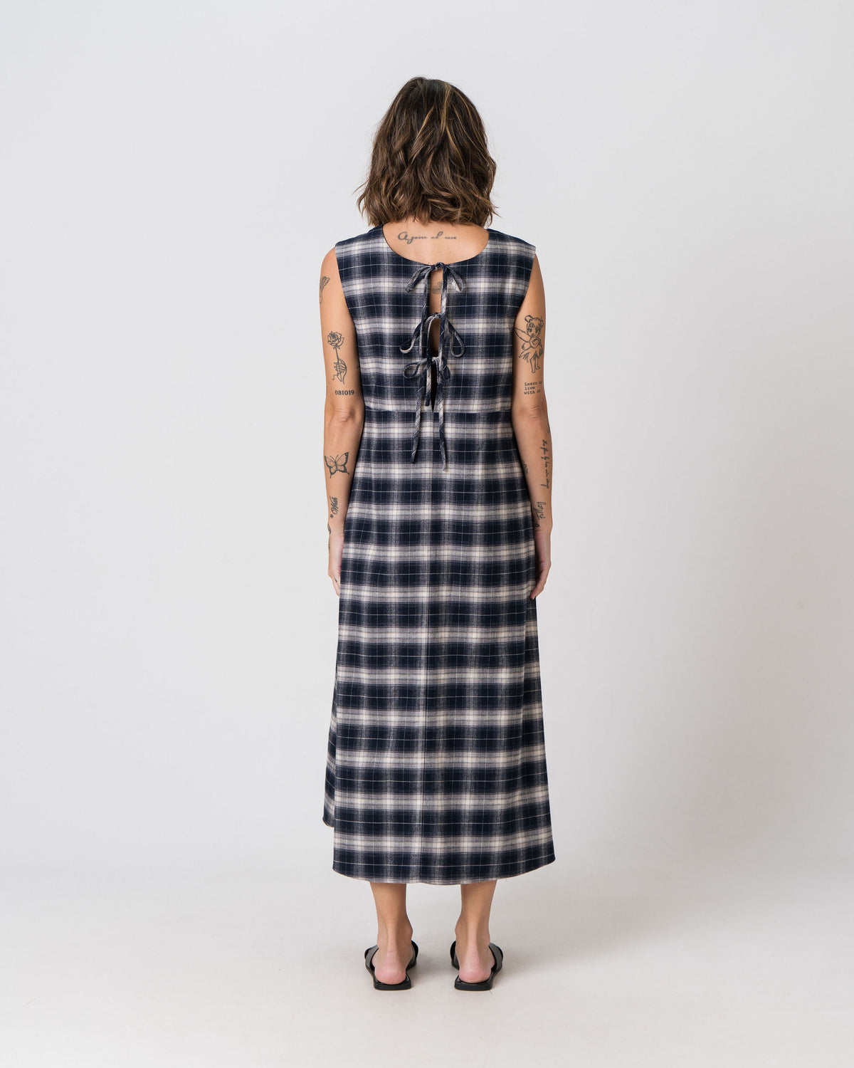 Back view of the Lenelly Bridget flannel dress in navy and cream plaid, showing the tie detail at the back neckline