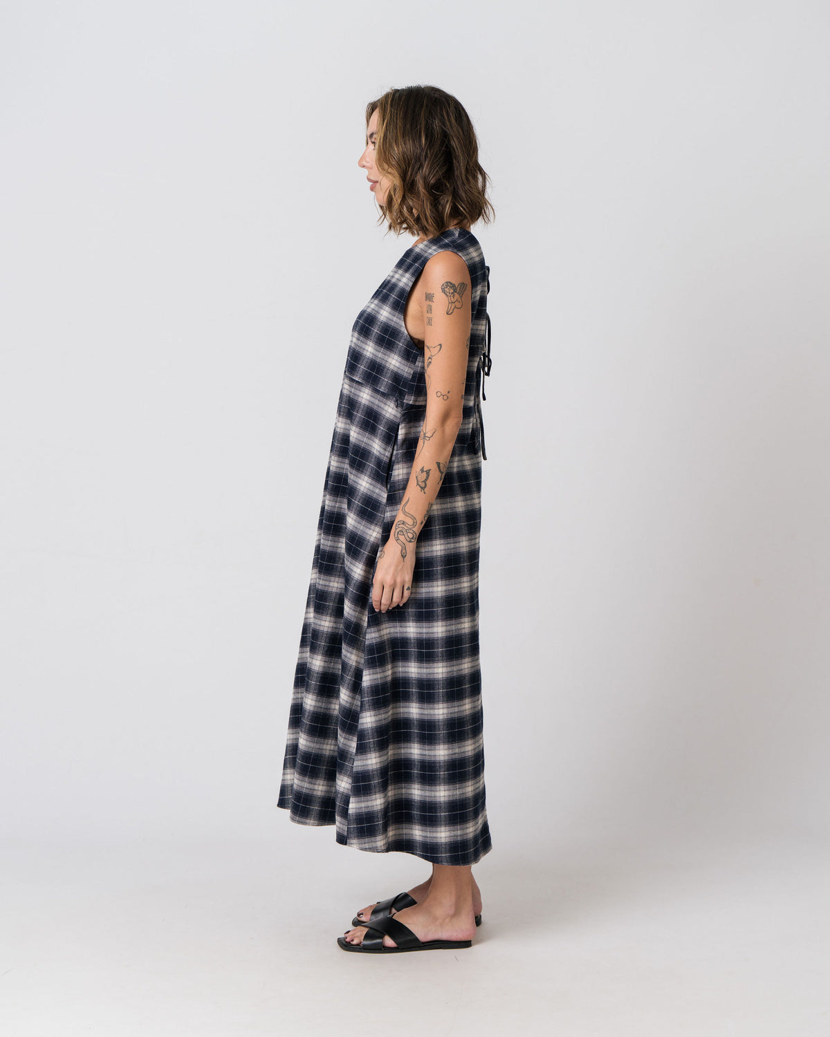Side view of the Lenelly Bridget flannel midi dress in navy and cream plaid showing the relaxed A-line silhouette
