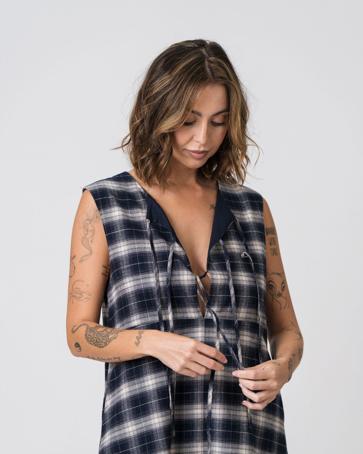 Close-up of the bow-tie front detail and navy contrast lining on the reverse side of the Lenelly Bridget flannel dress