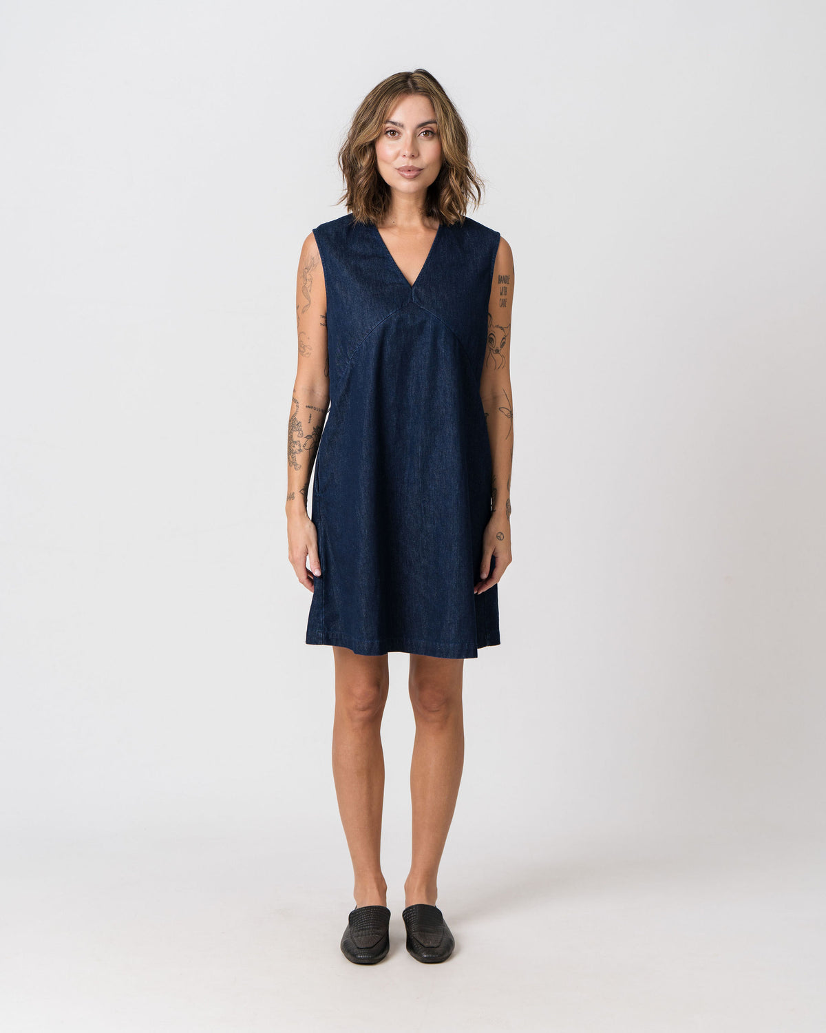 Lenelly Frankie denim dress in indigo, sleeveless V-neck breastfeeding-friendly shift dress, front view on a white background