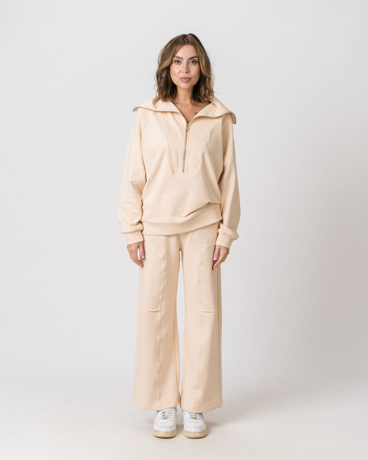 Lenelly Mish half zip nursing sweatshirt in apricot worn with the matching Mish sweatpants, front view on a light studio background