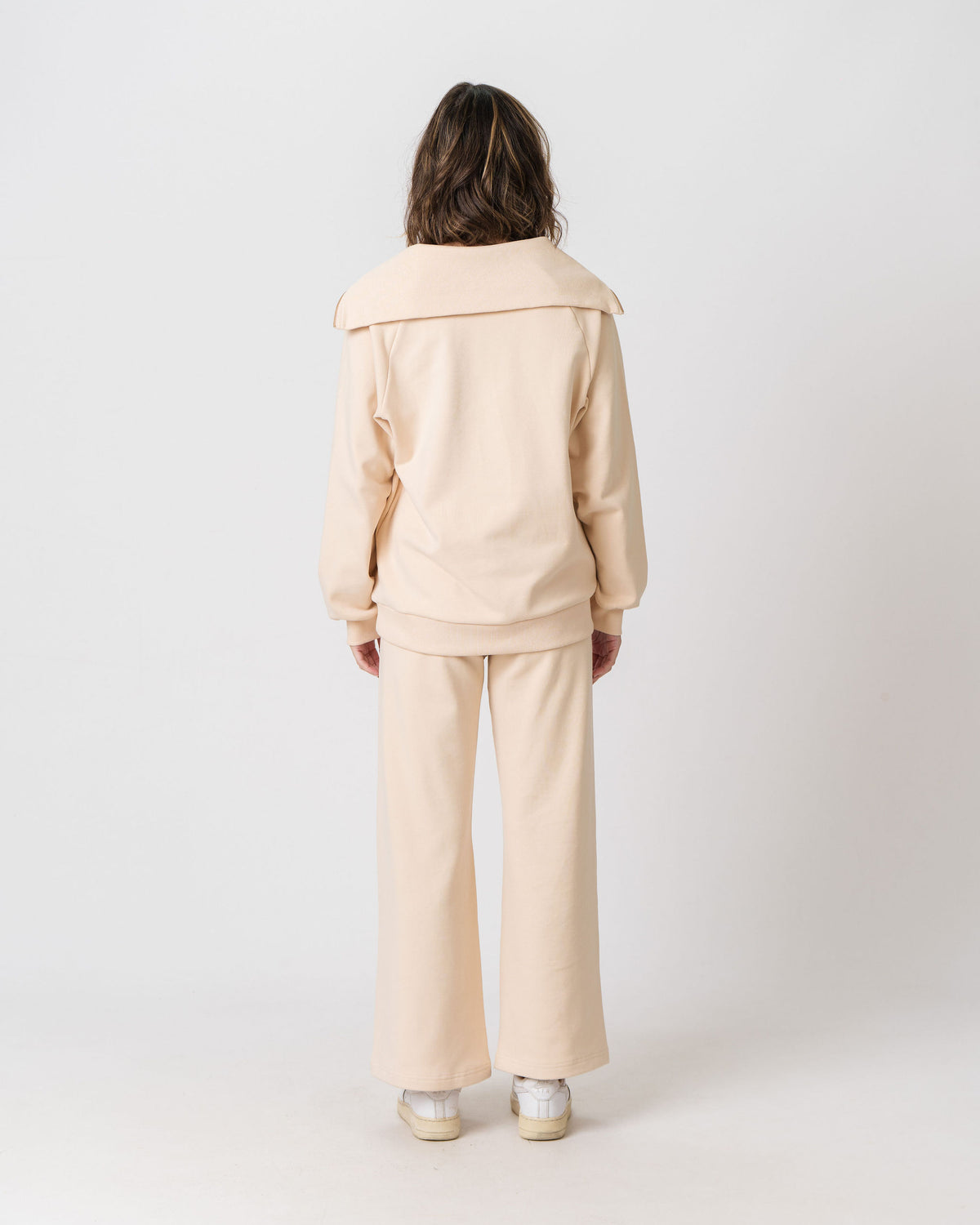 Back view of the Lenelly Mish half zip sweatshirt in apricot, showing the oversized fold-over collar