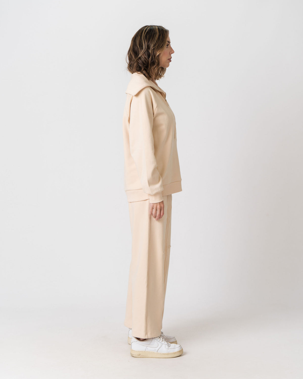 Side view of the Lenelly Mish half zip nursing sweatshirt in apricot with the matching sweatpants