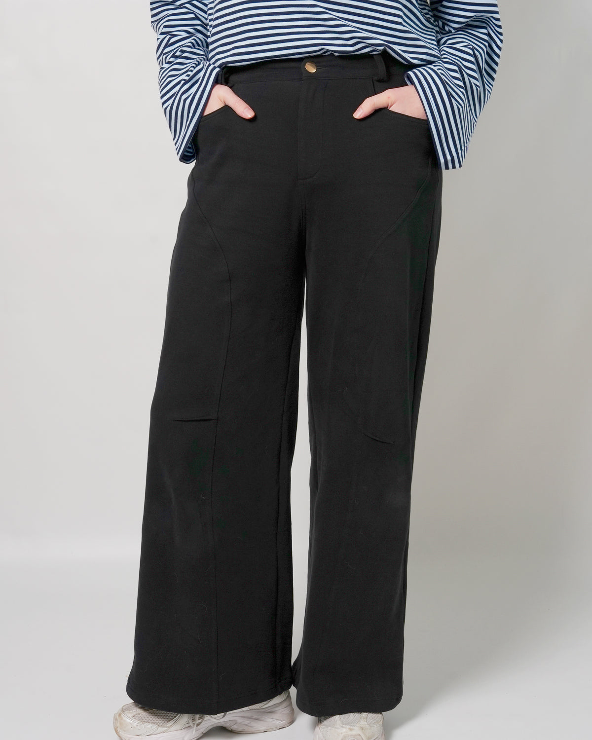 Lenelly Mish sweatpants in black styled with a navy striped long sleeve top, cropped front view with hands in the pockets