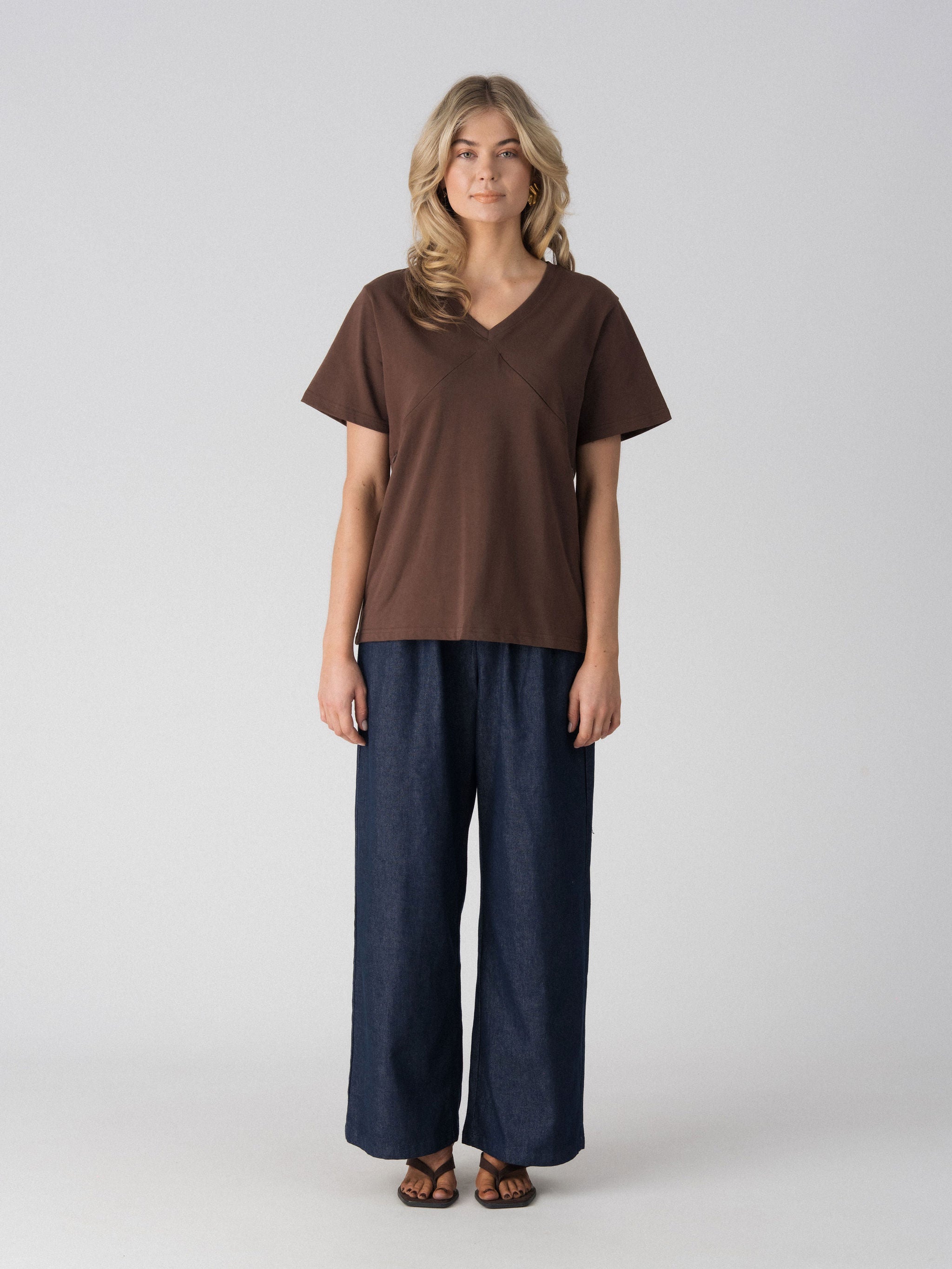 Lenelly Avery V-neck nursing tee in brown, an oversized breastfeeding-friendly tee styled with wide leg jeans, front view