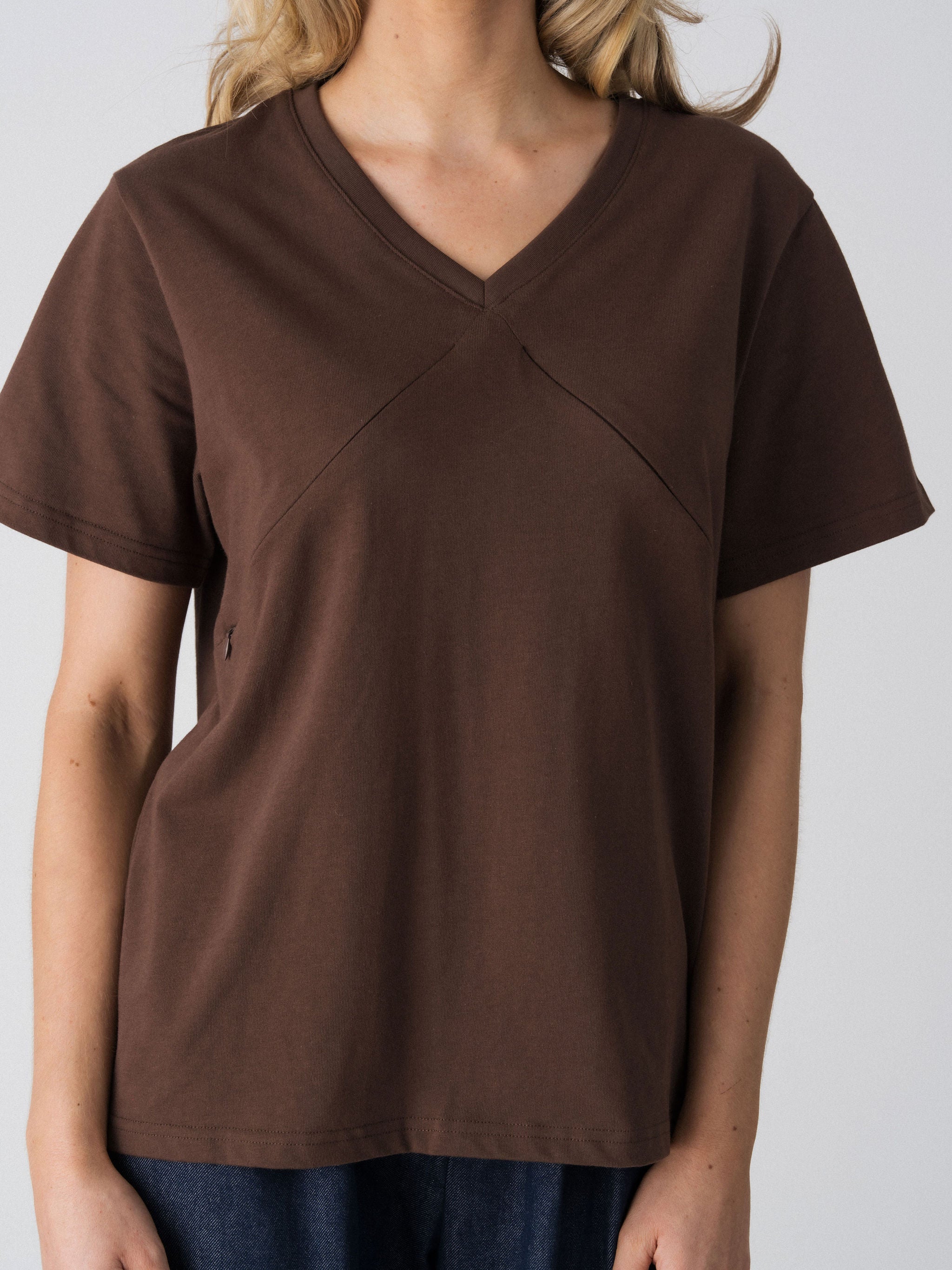 Close-up of the V-neckline and diagonal seam detail on the Lenelly Avery nursing tee in brown