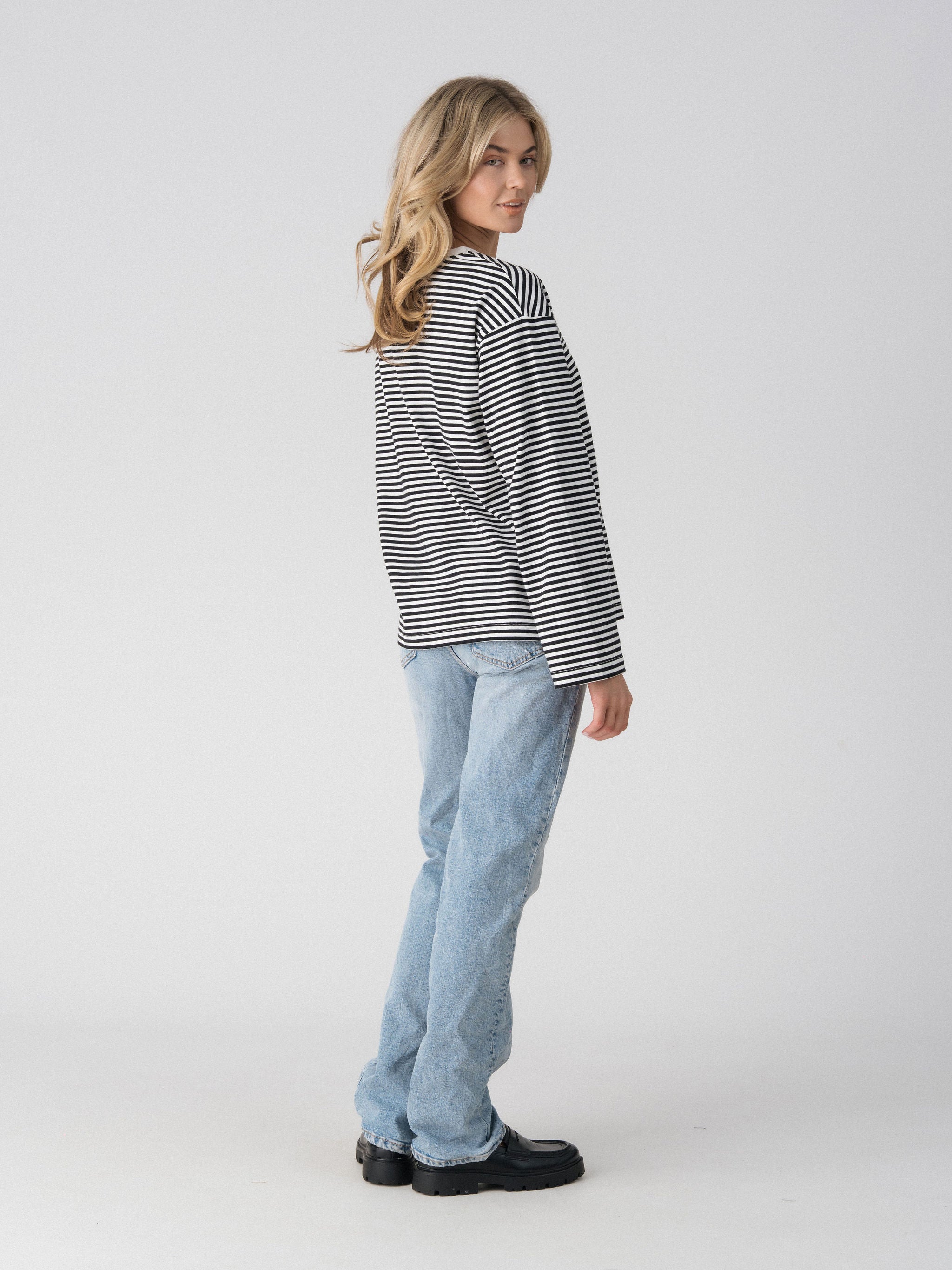 Lenelly Lena oversized striped nursing tee in black and white, side view showing the drop shoulder and relaxed fit