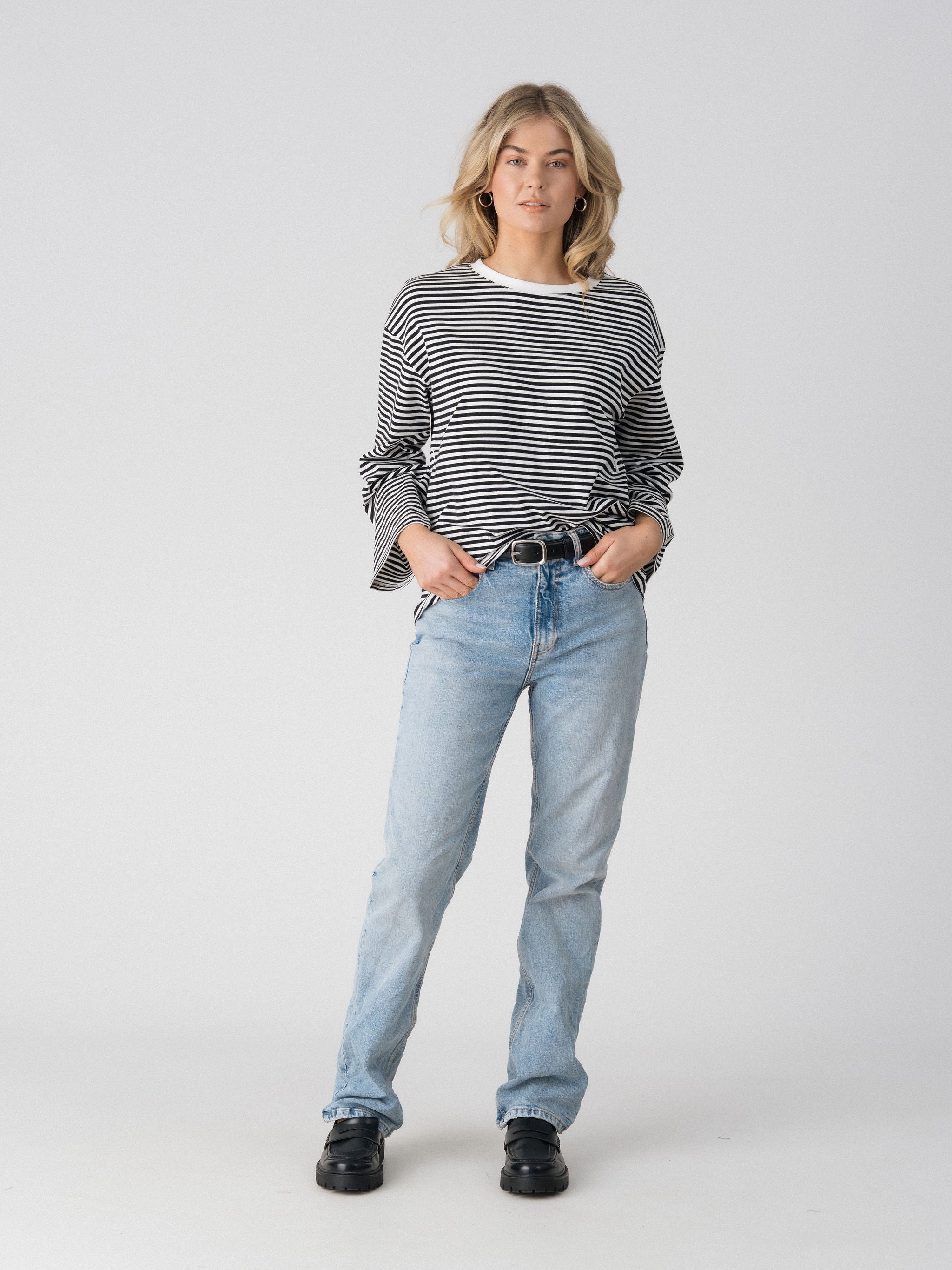 Lenelly Lena long sleeve striped tee in black and white worn tucked with a belt, front view