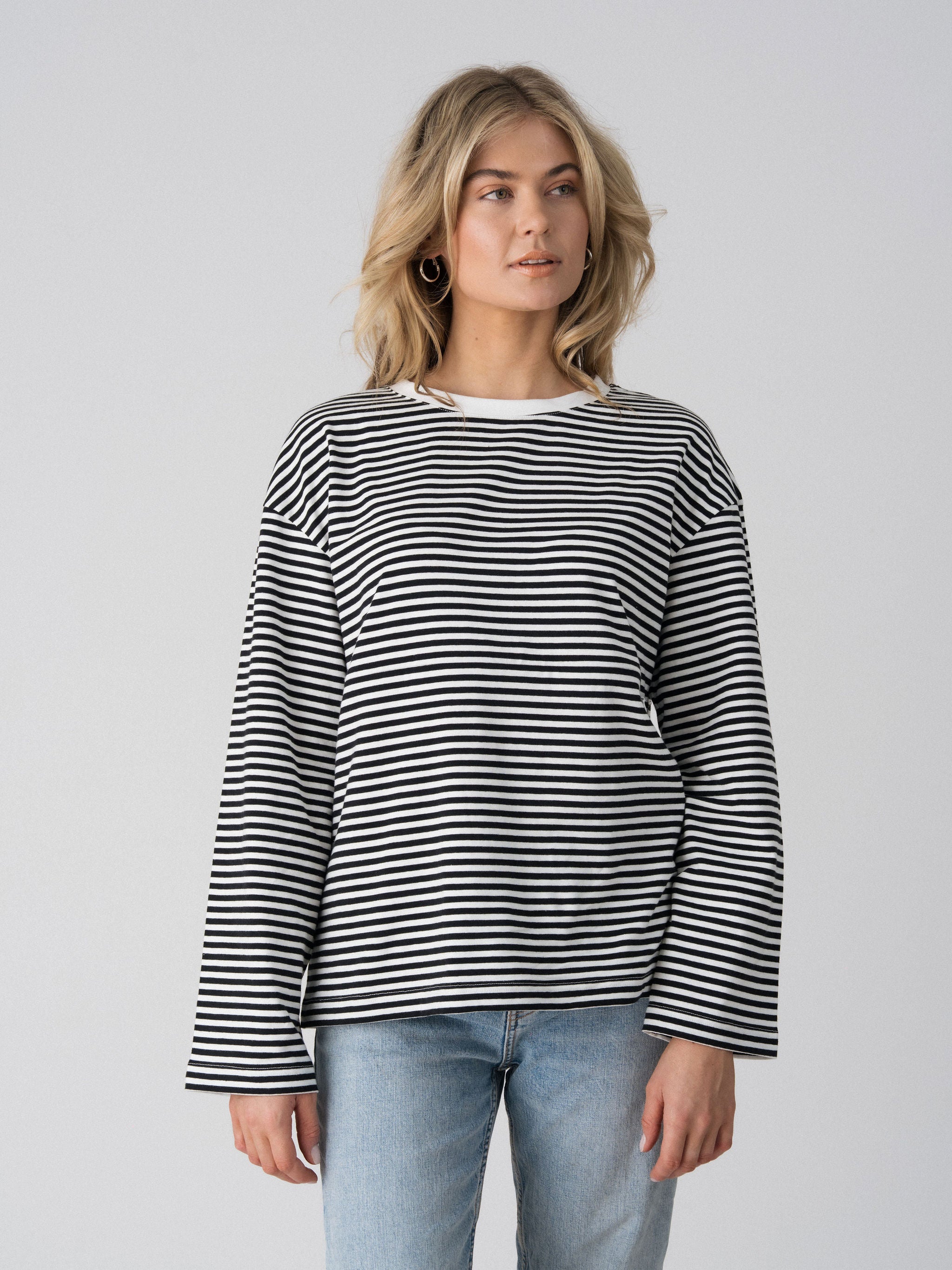 Close-up of the Lenelly Lena oversized nursing tee in black and white stripe, showing the wide sleeve and crew neckline