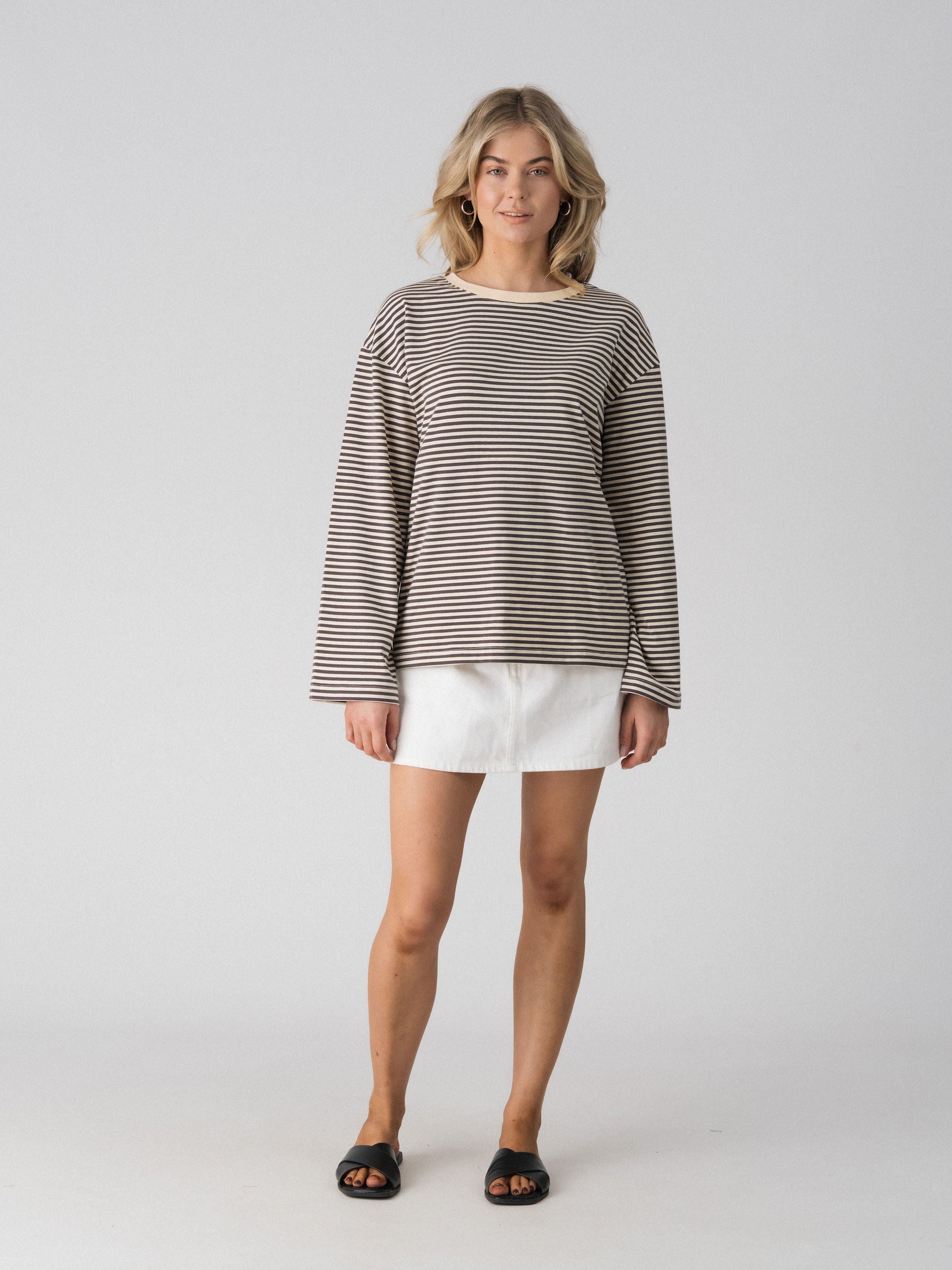 Lenelly Lena oversized long sleeve nursing tee in grey and off-white stripe, a breastfeeding-friendly top styled with a white denim skirt, front view