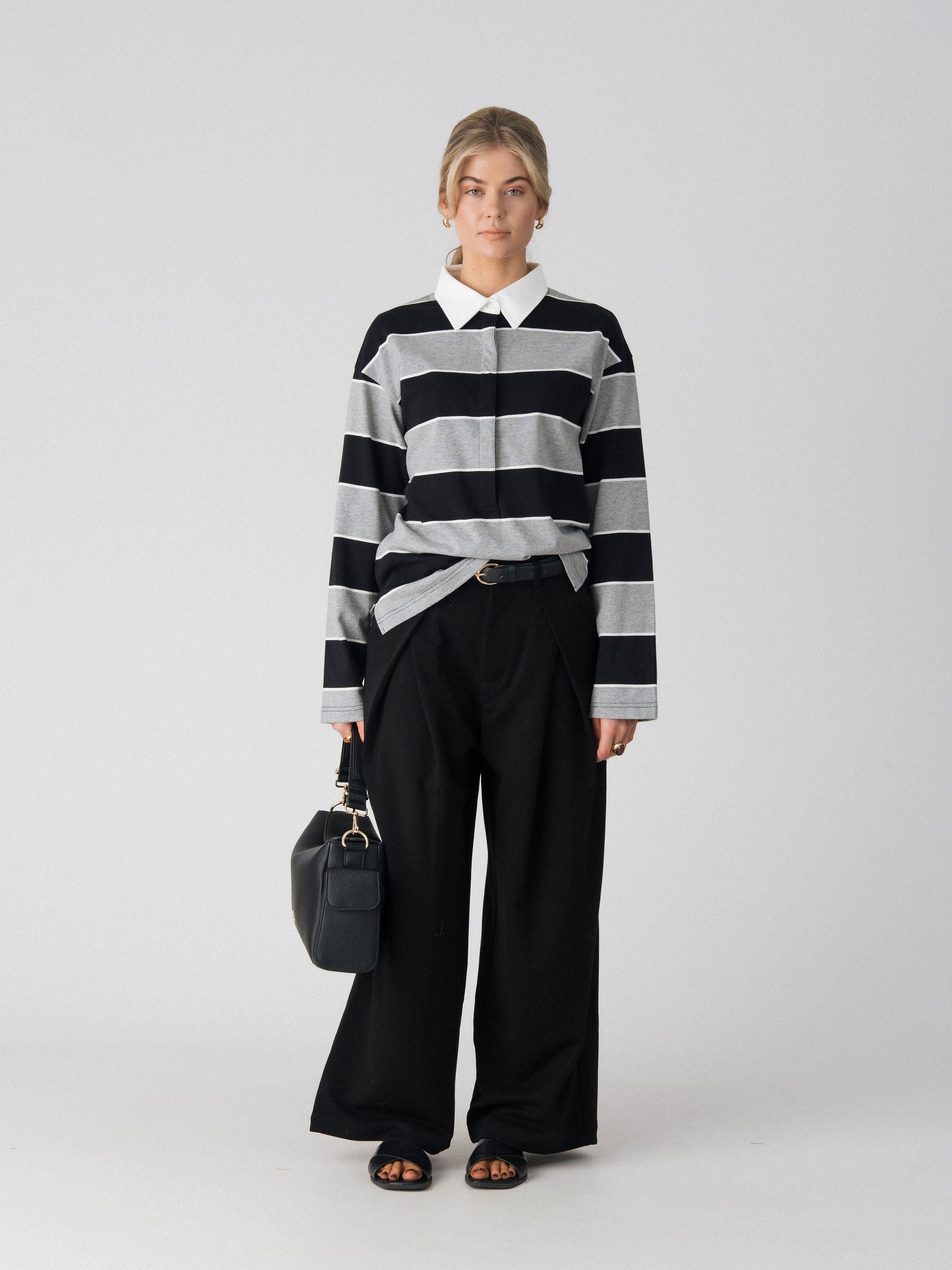 Lenelly Erika rugby polo in black and grey stripe worn with the Lenelly Hera pram caddy bag in black