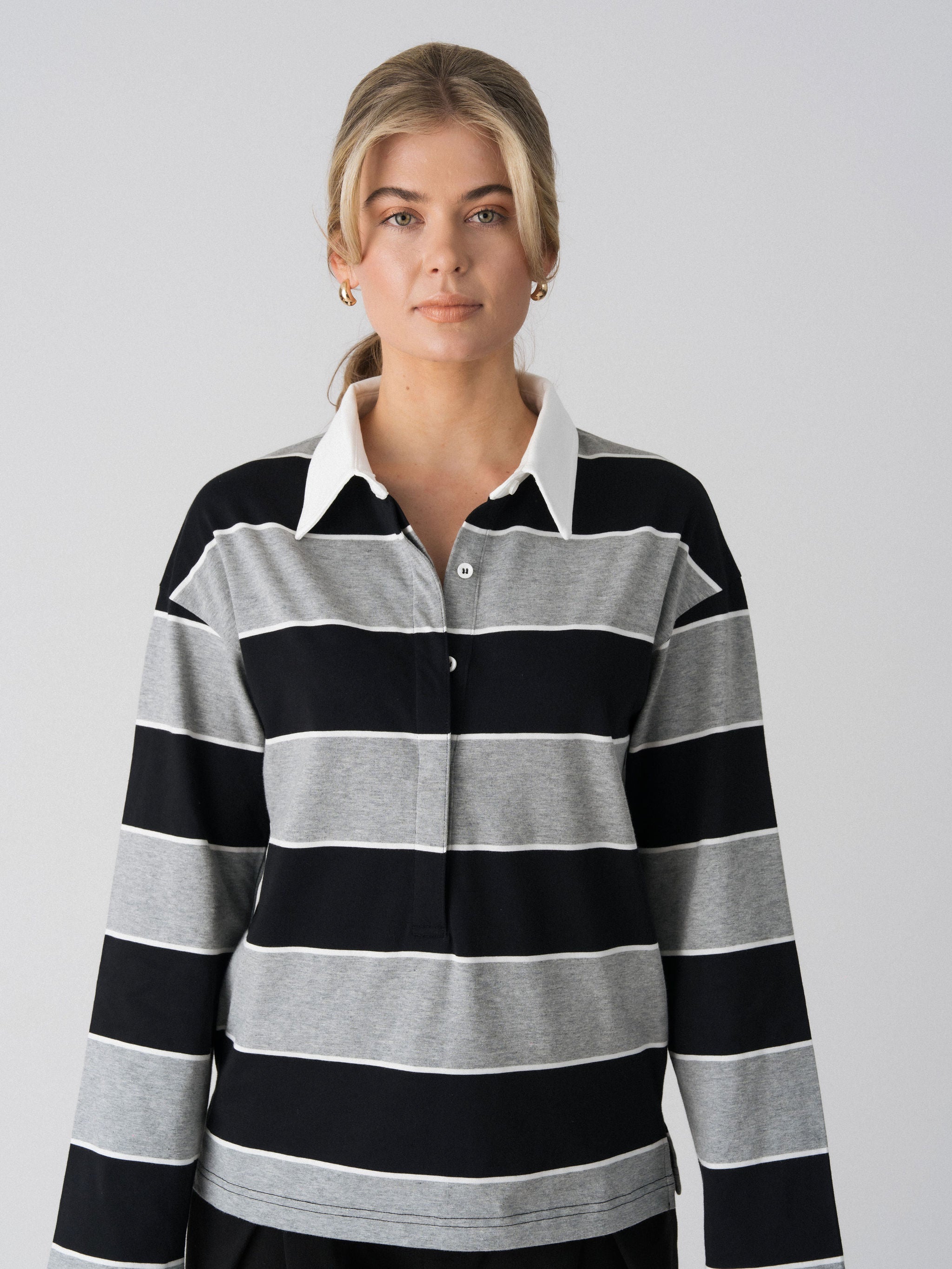 Close-up of the white collar and concealed button placket on the Lenelly Erika rugby nursing polo