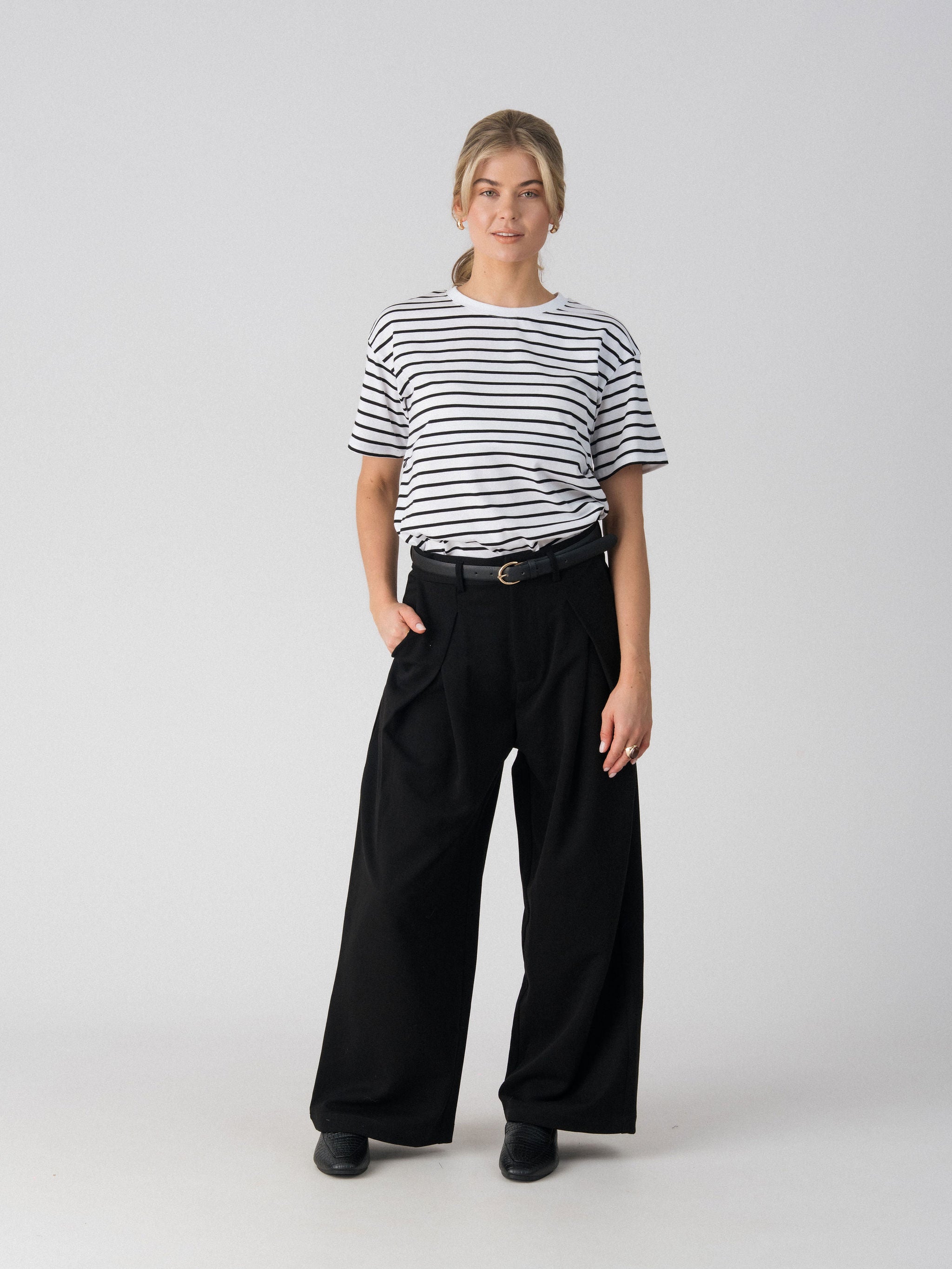Lenelly Issa striped nursing tee in white and black styled with black wide leg trousers and a belt, front view