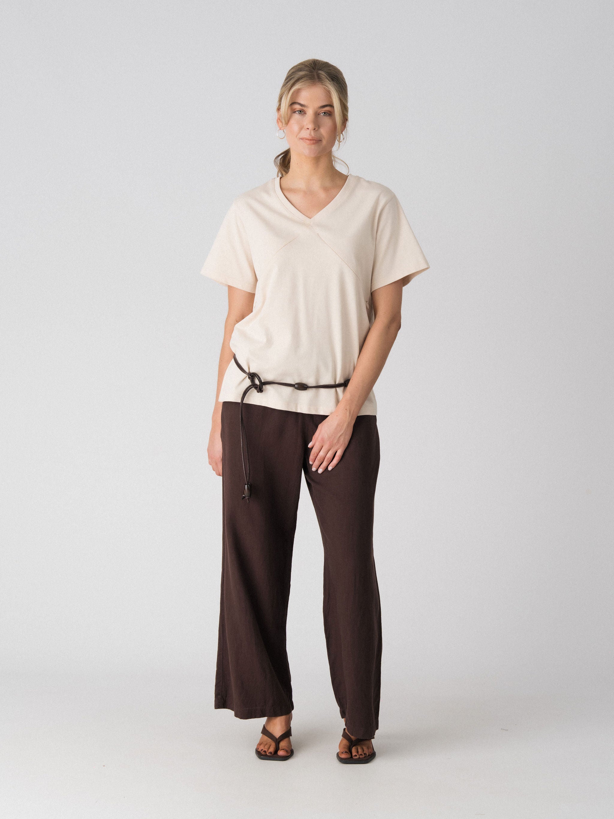 Lenelly Avery V-neck nursing tee in sand, an oversized breastfeeding-friendly tee styled with a cord belt and wide leg trousers, front view