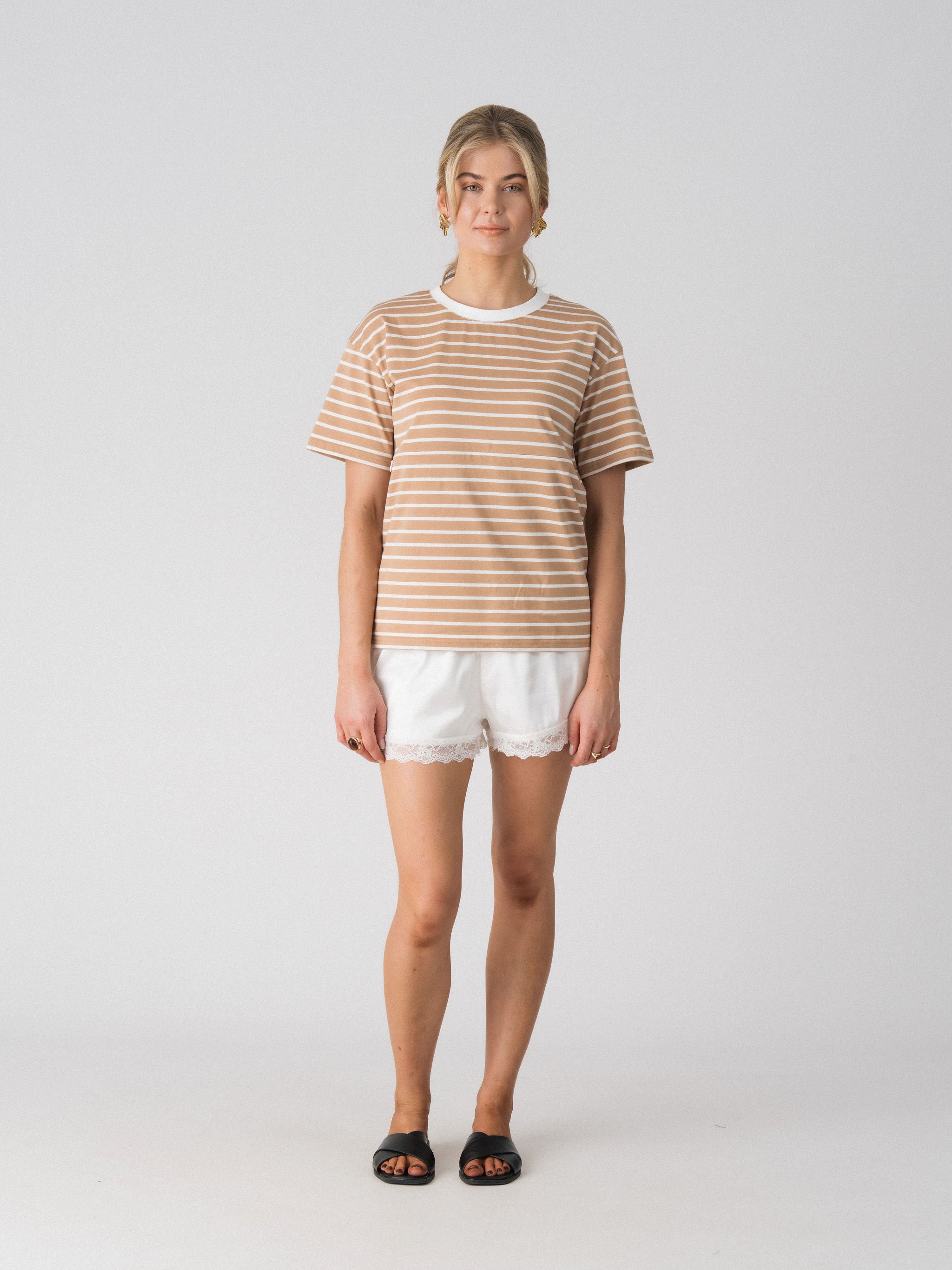 Lenelly Issa everyday striped nursing tee in tan and white, a breastfeeding-friendly tee styled with white lace trim shorts, front view