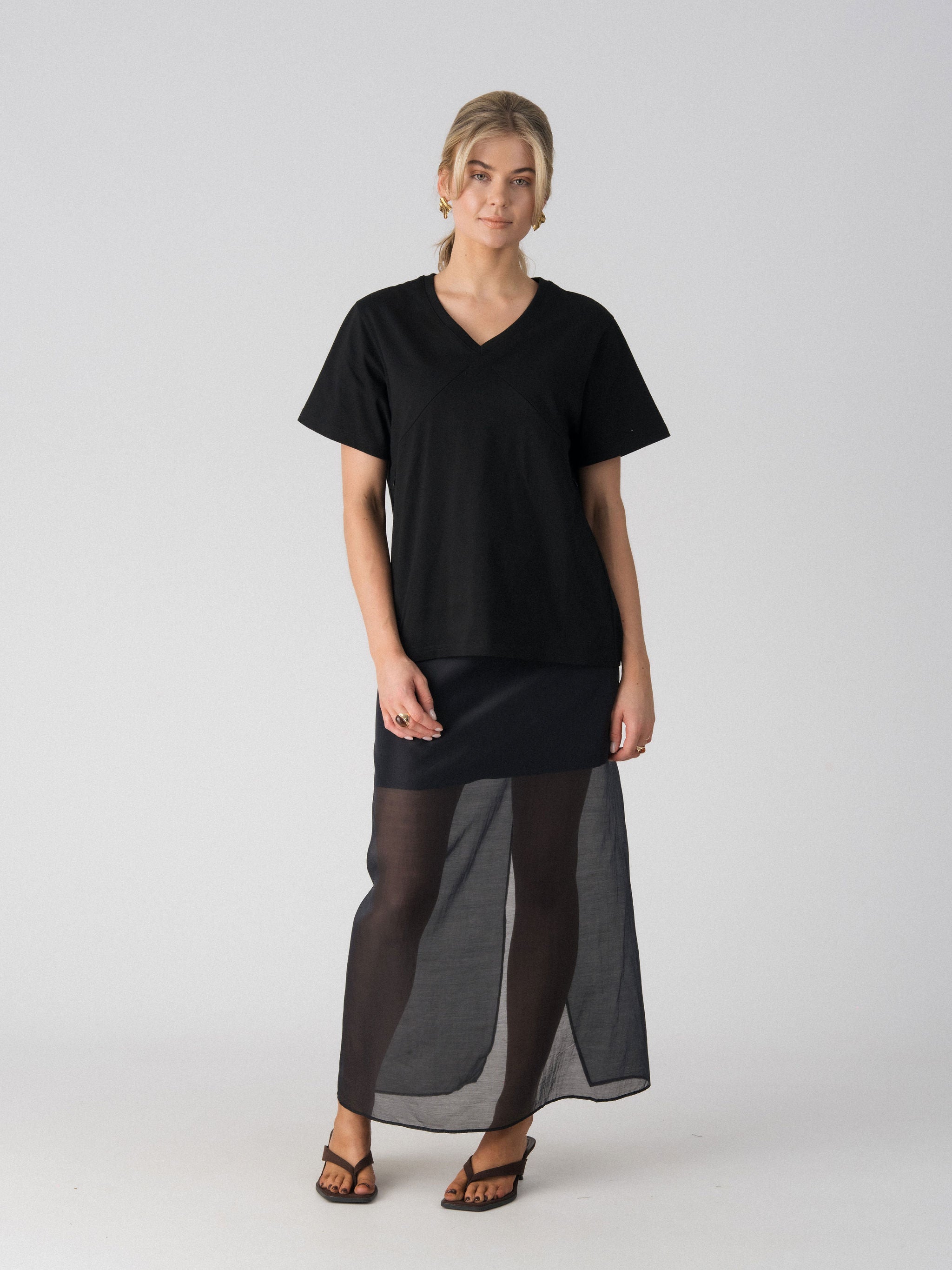 Lenelly Avery V-neck nursing tee in black, an oversized breastfeeding-friendly tee styled with a sheer maxi skirt, front view