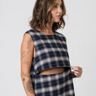 Woman wearing plaid dress with horizonal two-way zip for breastfeeding access.
