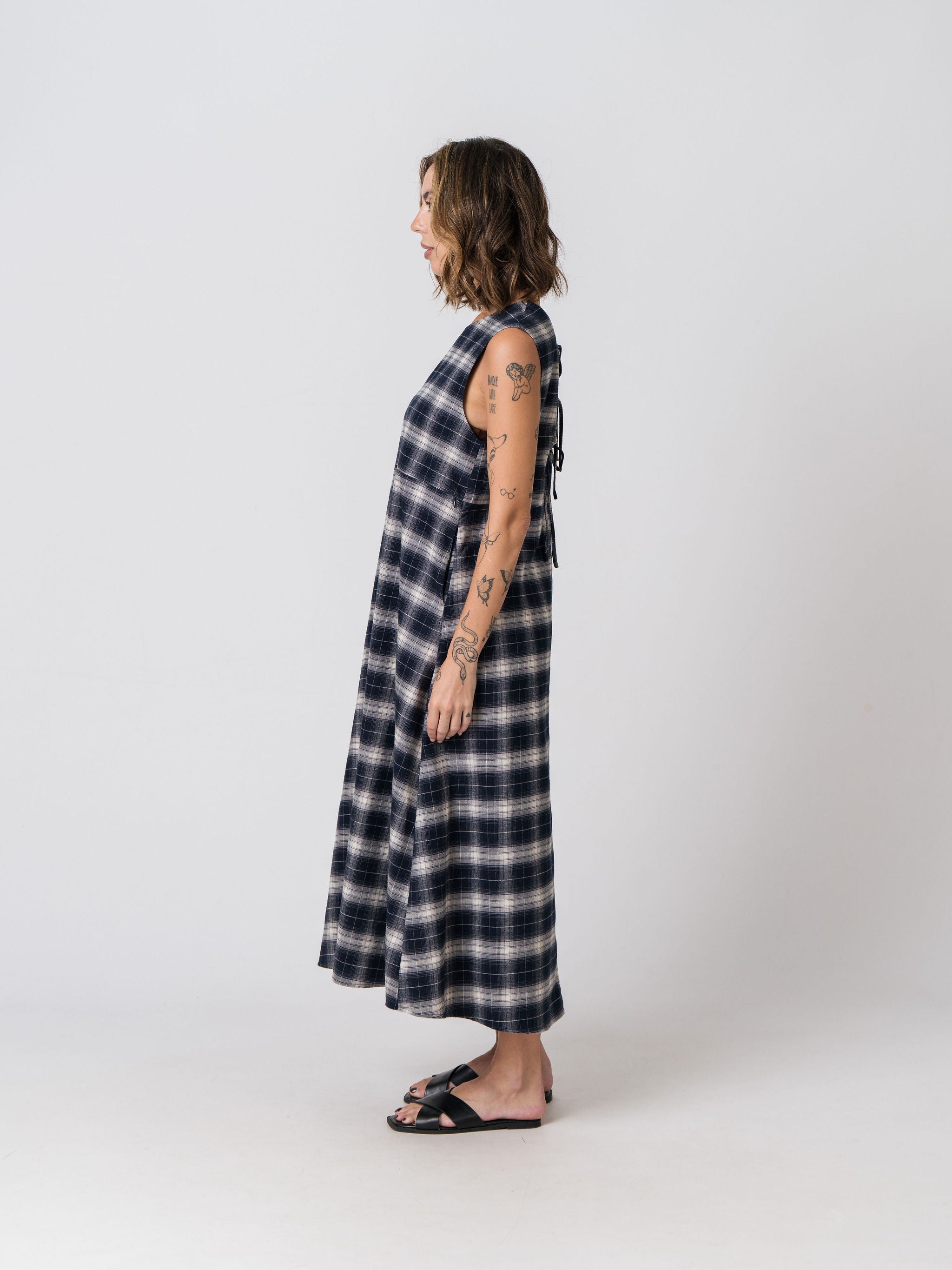 Side view of the Lenelly Bridget flannel midi dress in navy and cream plaid showing the relaxed A-line silhouette