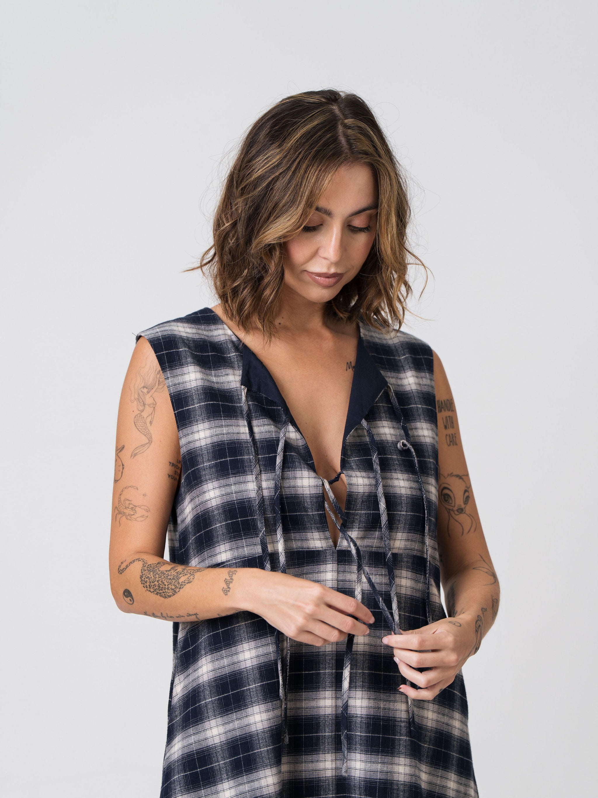 Close-up of the bow-tie front detail and navy contrast lining on the reverse side of the Lenelly Bridget flannel dress