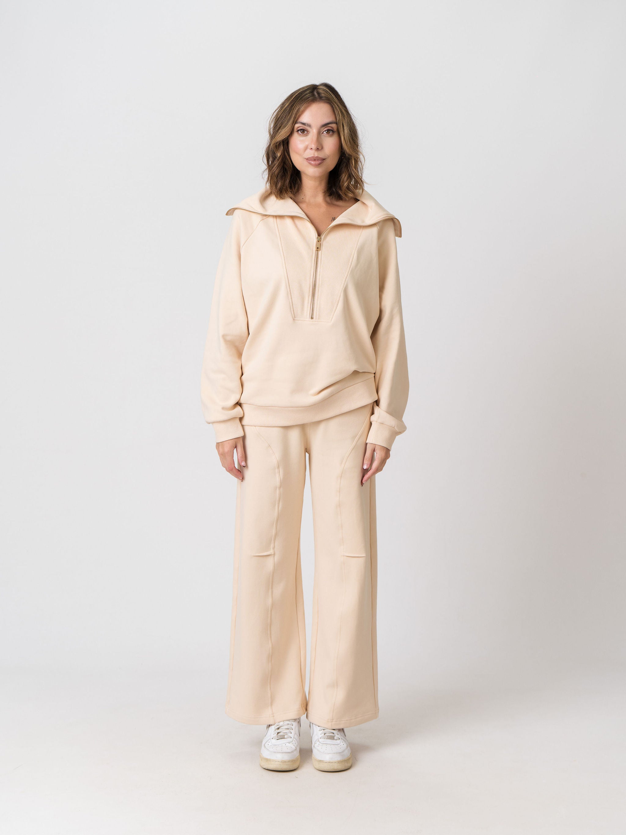 Lenelly Mish half zip nursing sweatshirt in apricot worn with the matching Mish sweatpants, front view on a light studio background