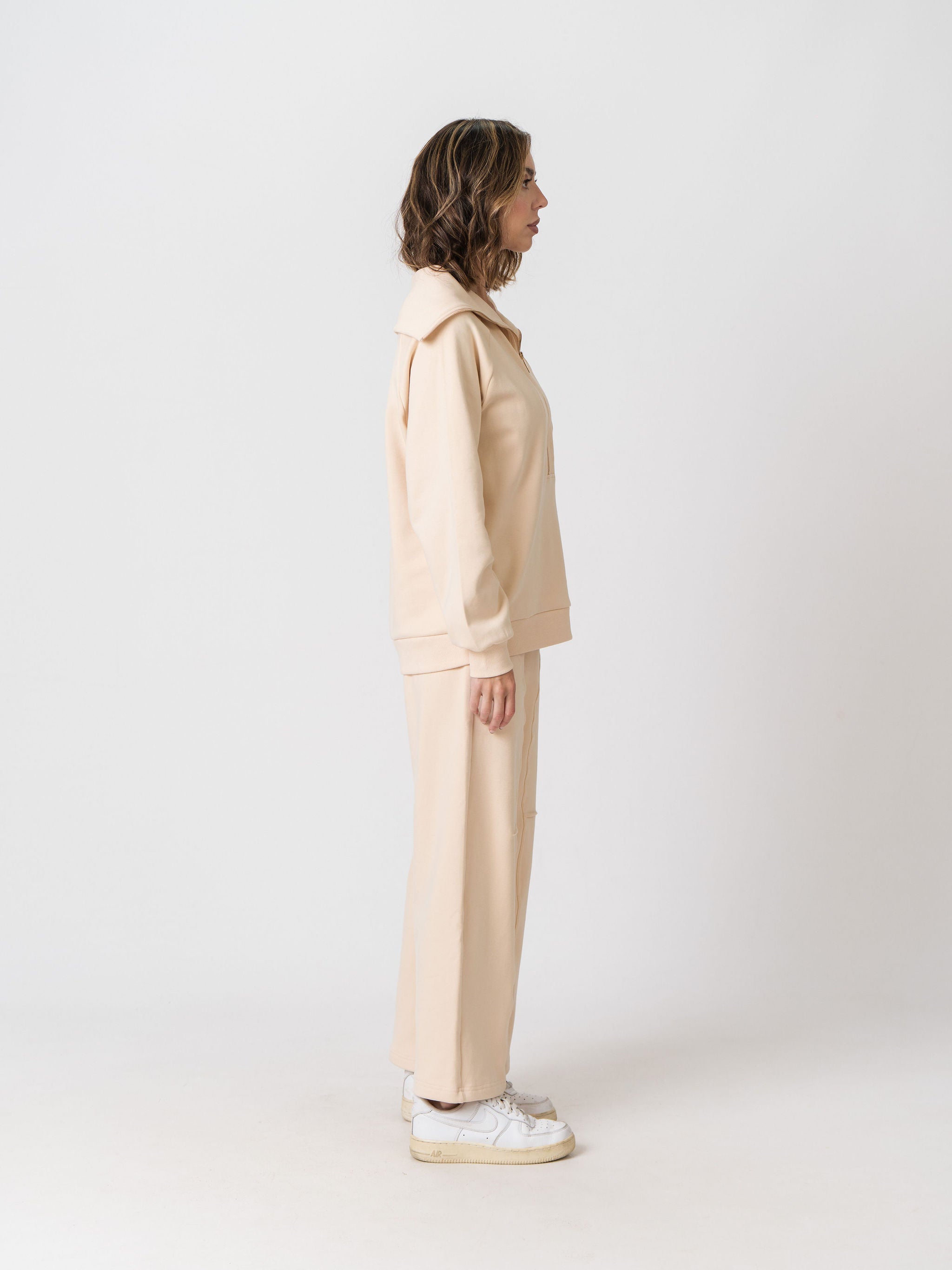 Side view of the Lenelly Mish half zip nursing sweatshirt in apricot with the matching sweatpants