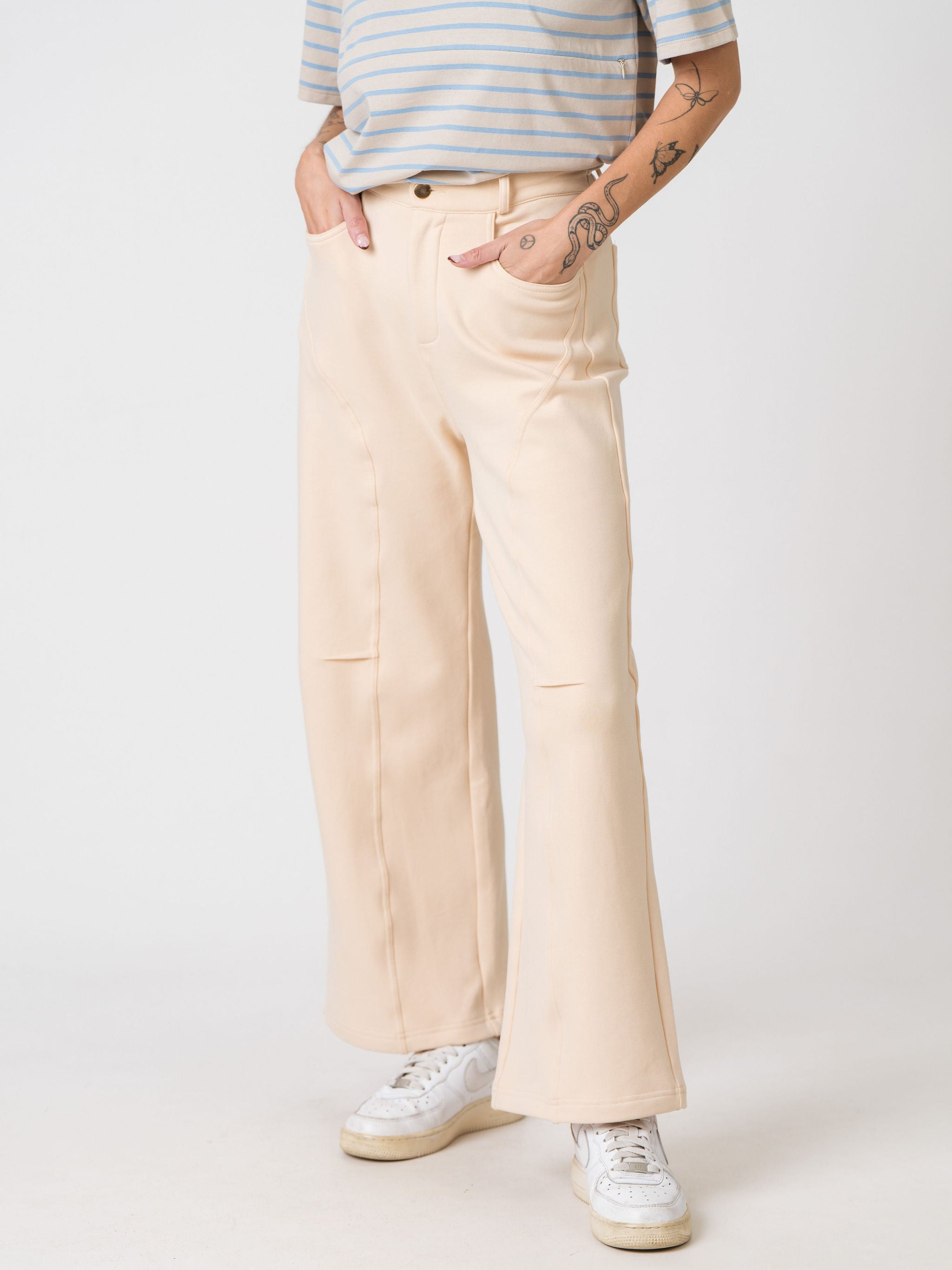 Lenelly Mish sweatpants in apricot showing the button and zip front and side pockets, cropped front view