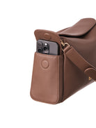 Lenelly Hera pram caddy bag in brown vegan leather with adjustable strap, side view on white background with phone in side pocket