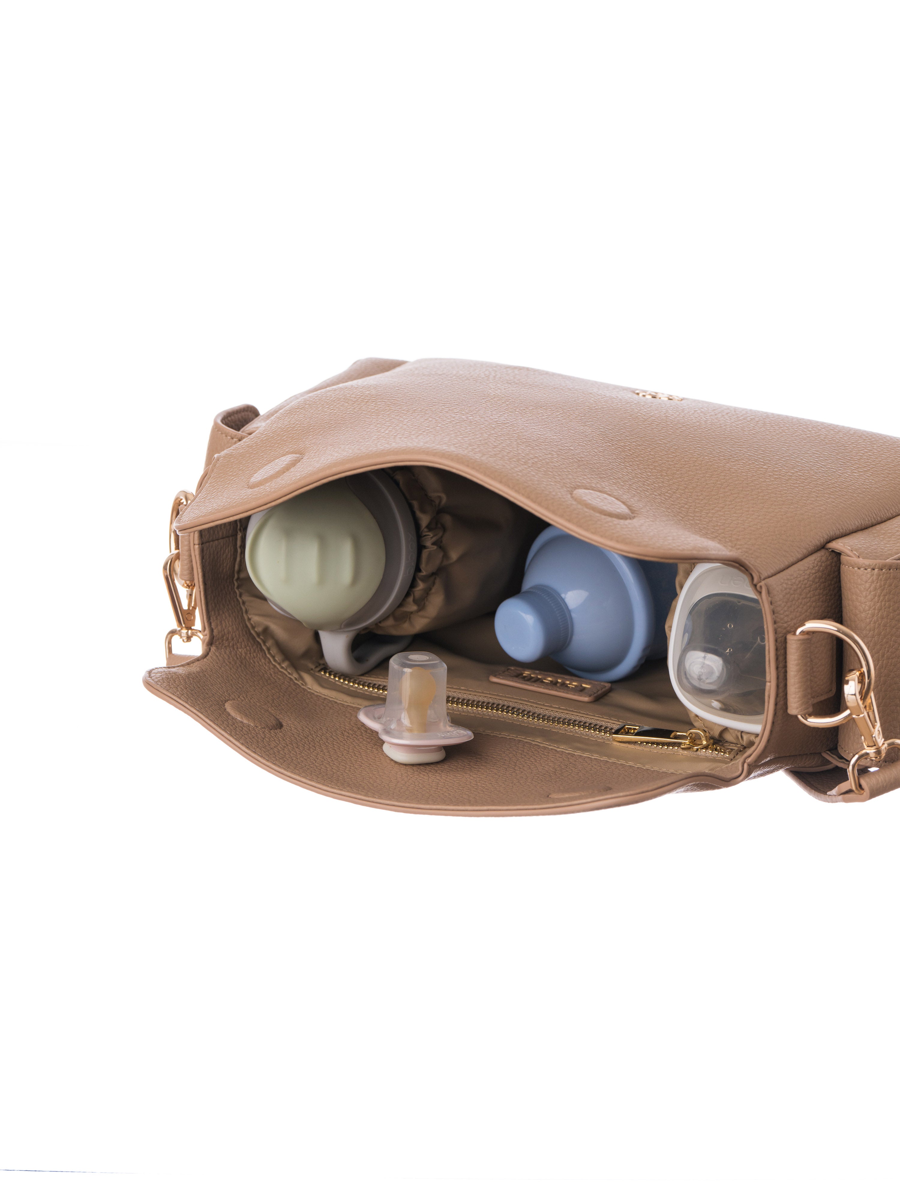 Lenelly Hera pram caddy bag in sand vegan leather with adjustable strap, styled interior view on white background with baby bottle, formula container, water sippy cup and dummy pacifier
